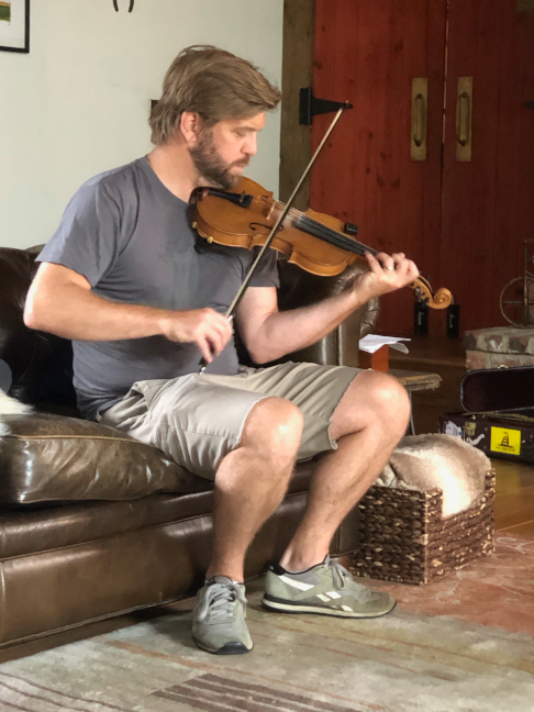 Nick warms up his fiddle